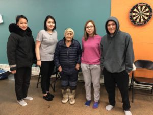 Youth from Arviat host a caribou skinning and hide tanning workshop with the help of elder Mary Anowtalik. From left to right: Andrea Alikut, Natalie Uluadluak, Mary Anowtalik, Kirsten Pameolik, and Randy Anowtalik. (credit: Michelle Ewacha, CPAWS Manitoba.)