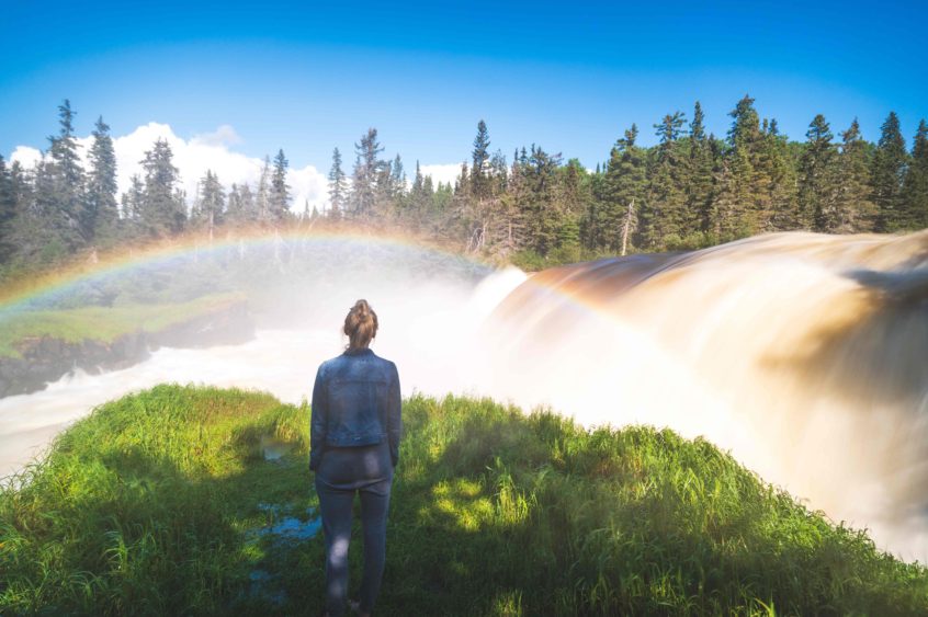 Avery Kash looking at waterfall and rainbow.
