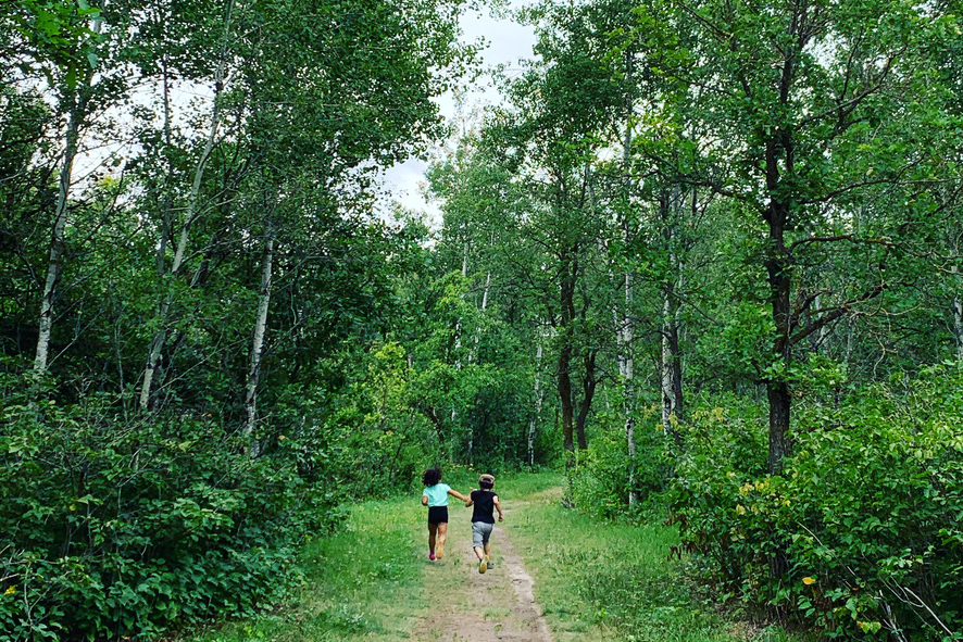 Children running through forest