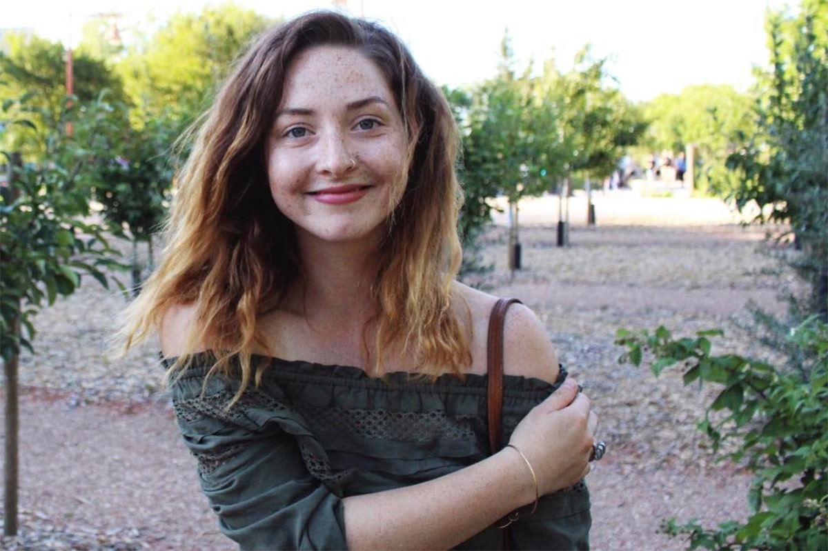 Riley Chervinski standing in an orchard.