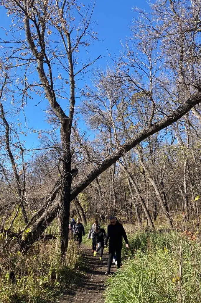 People hiking through a forest on La Barrière Park Loop.