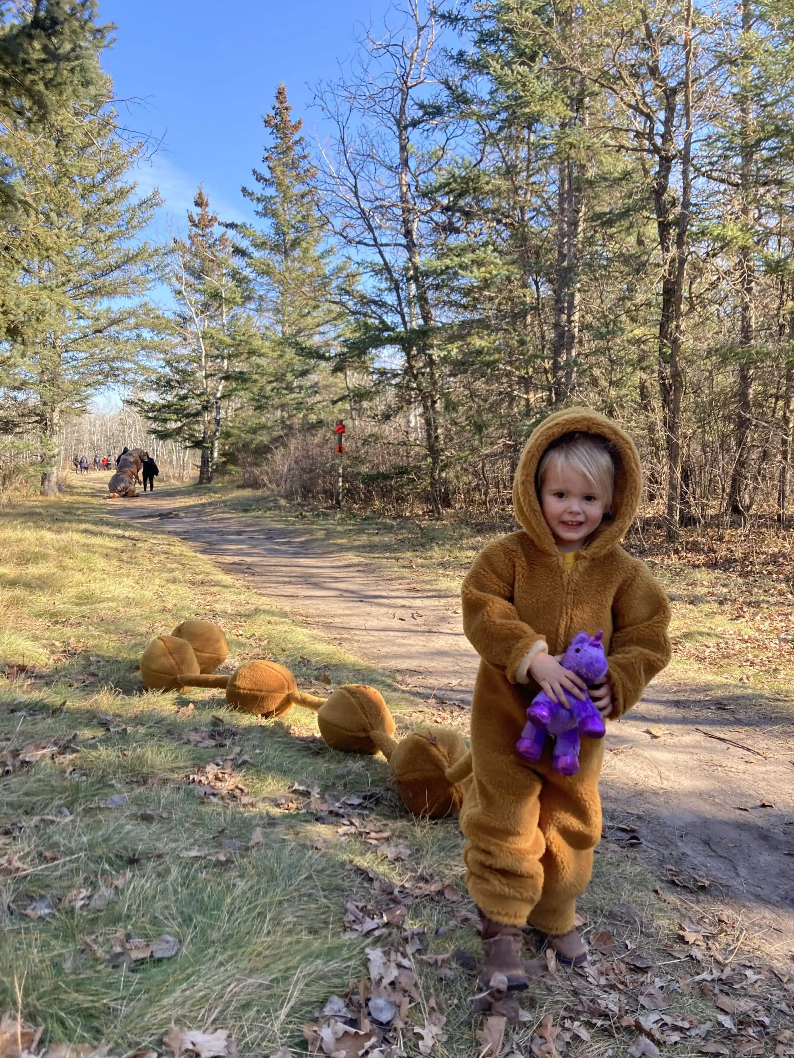 Cute kids in costumes having fun in the woods at our Halloween Hike in Birds Hill