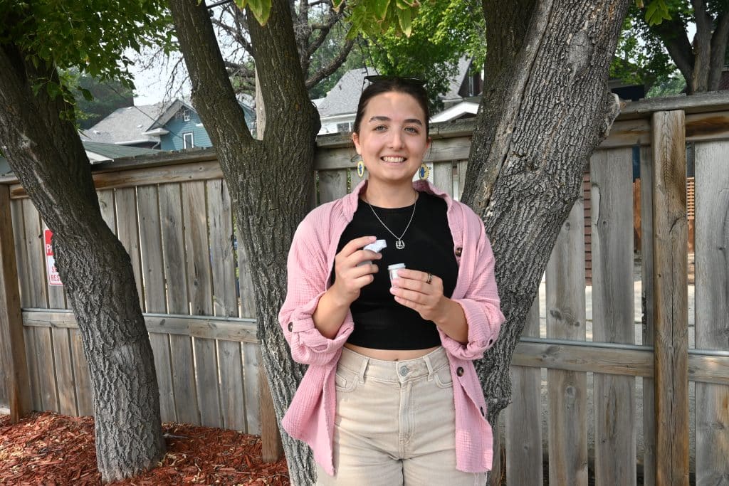 Nadia posing with the geocache she found