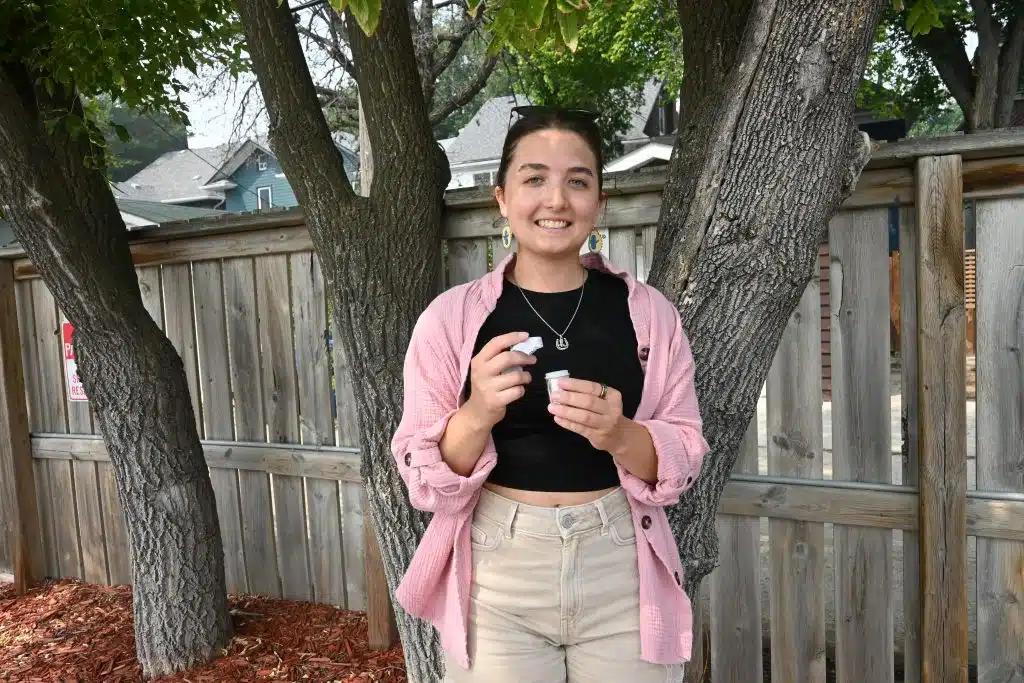 Nadia posing with the geocache she found