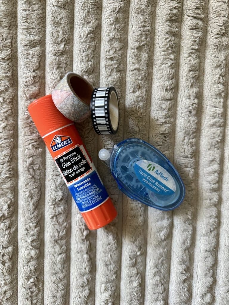 Sticky things for journaling, including a glue stick, washi tape, and a tape glue runner.
