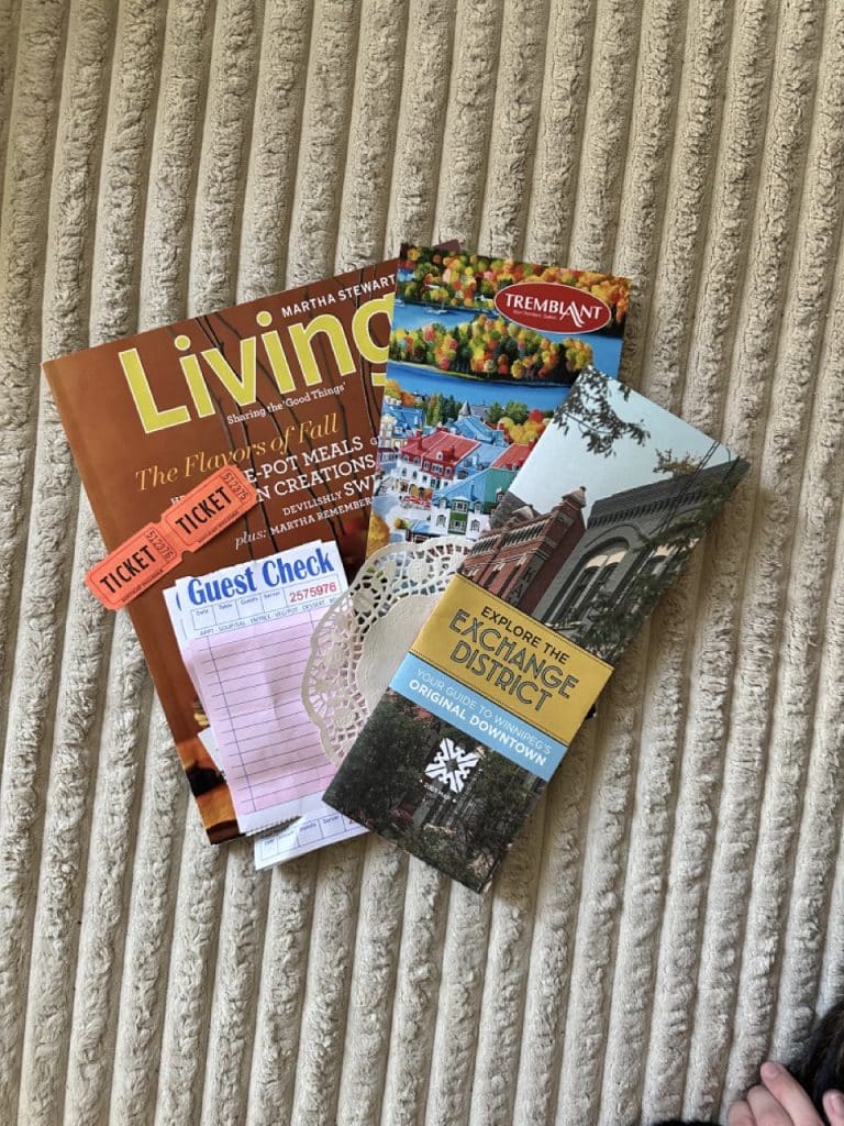 Miscellaneous "junk" used for a journal spread. Includes a magazine, postcard, map, doily, receipt, and ticket stubs.