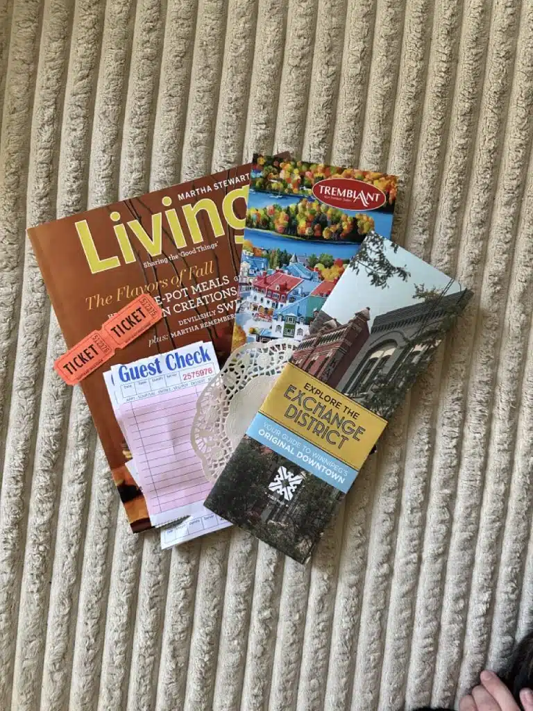 Miscellaneous "junk" used for a journal spread. Includes a magazine, postcard, map, doily, receipt, and ticket stubs.